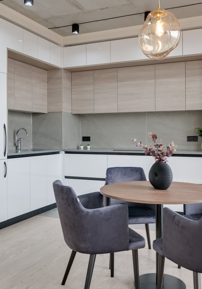 Services Contemporary kitchen interior with sleek furniture and stylish lighting in a modern apartment.